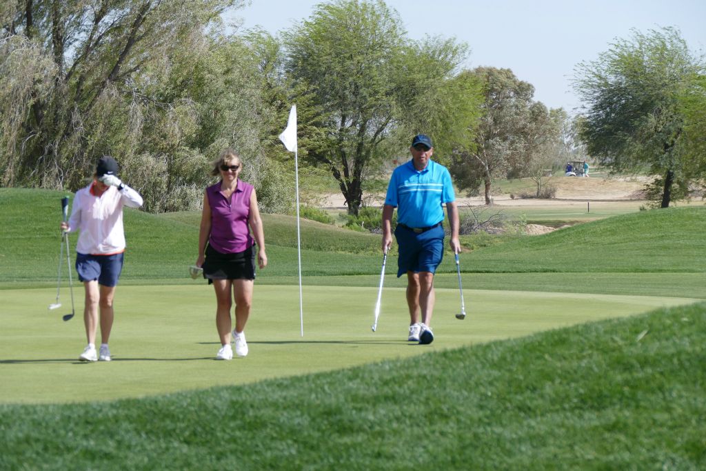 June, Sarah, and Mike walking off the green