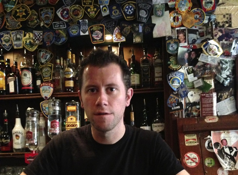 The bartender who spoke Gaelic for us. On the wall, lots of police and fire patches from around the world. 